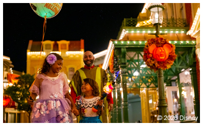 people enjoying a nighttime on main street at Mickey's Not-So-Scary Halloween Party