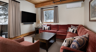 Photo of hotel room living space with large couch.