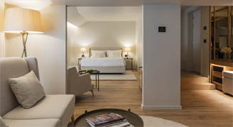 Image of a living area and bed in a One-Bedroom Suite.