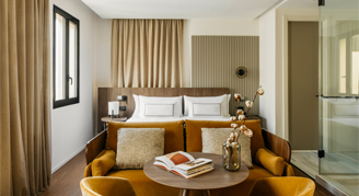 Photo of hotel suite with king bed and seating area.