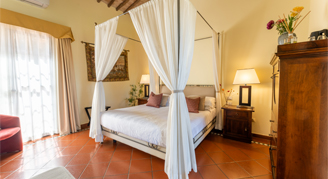 Image of a single bed in a Classic Room with Terrance adjacent to a large window.