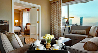 A view of the living room area of the Signature Bay-View Suite with the bedroom in the background.