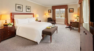 Image of a Junior Suite with one king, working desk and adjacent window.