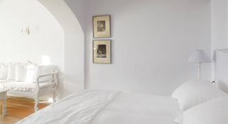 Bedroom with all white furniture and interior design.