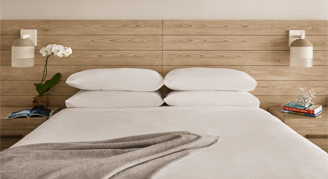 Image of a single bed in a Waikiki-Mountain-View Room.