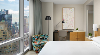 Image of a single bed in a High-Floor Times Square-View Room.