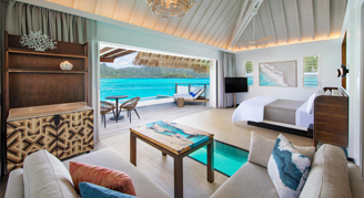 Image of a single bed leading to an open balcony in a Premium Otemanu-View Overwater Villa with Plunge Pool.