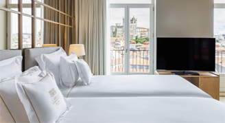 Image of two beds in a Cathedral-View Premium Room with Balcony.