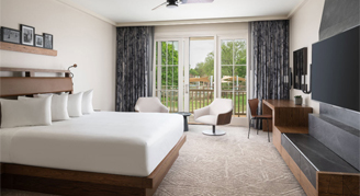 Presidential Suite with a king bed, mounted TV and patio view