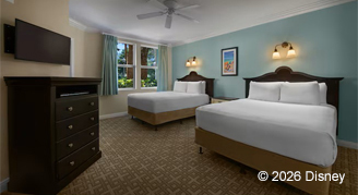 Mobility accessible deluxe studio with light blue wall color featuring two queen beds and mounted TV.