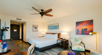 Image of a single bed and chair in a Deluxe Room.