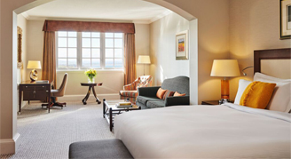 Image of the Studio Suite with one bed, work desk and wide-adjacent window.