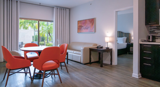 Image of the living space of The Level suite, with dining table and chairs.