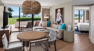 Image shows a combined sitting area, dining table and room area in the background.