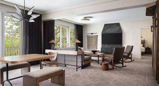 Suite with living and dining area with two windows with a view outside.