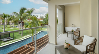 Image of a large balcony with chairs on it overlooking the resort.