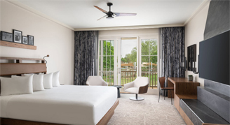 A view of the Presidential Suite with a King bed and mounted Television