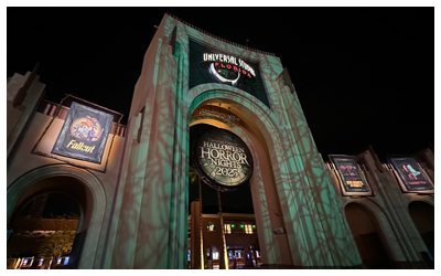 Nighttime photo of Universal Studios Florida's gates.