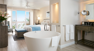 Photo of hotel room and bathroom with large soaker tub.