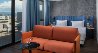 the sofa is in front of the bed, roof top view