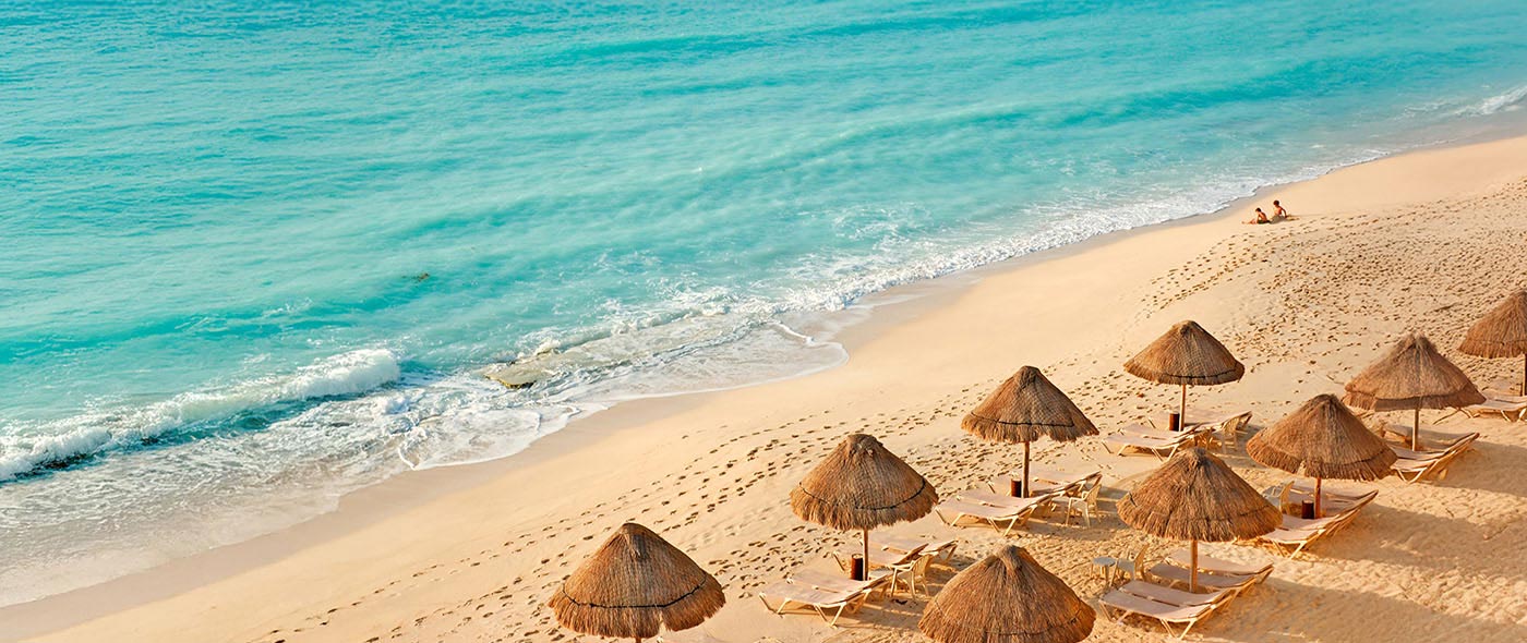 Beach chairs with umbrellas on the oceanfront