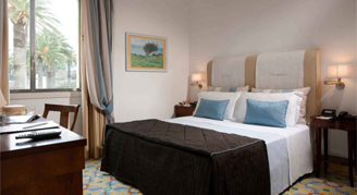 Photo of hotel room with window view of greenery.