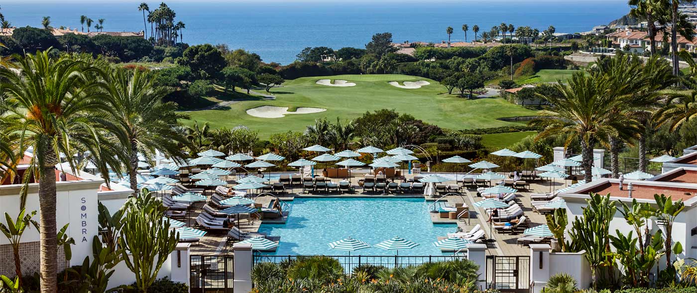 View of pool, golf course and the sea
