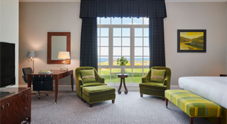 One king bed suite with green sofa