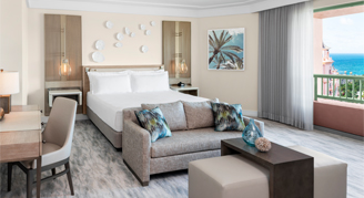 One bedroom regal suite with a king bed and sofa couch and lounge area.