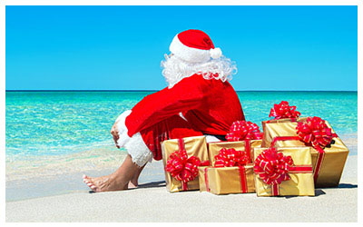 Image of Santa and gifts on a tropical beach.