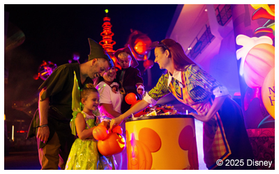 Woman in costume giving candy.