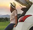 
								 Image of a woman alone with a rental car. 
							