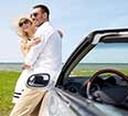 Image of a couple treating themselves to a convertible rental car.