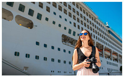 Image of a tourist in front of a cruise ship.